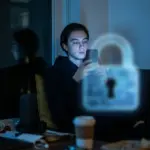 Person viewing smartphone with digital privacy lock symbol overlay