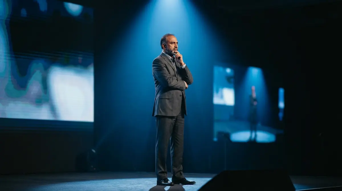 Infosys Chairman Nandan Nilekani speaking on stage about AI legacy code.